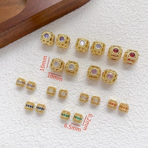 Vista detallada de cuentas huecas bañadas en oro de 18k con circonitas de colores para DIY