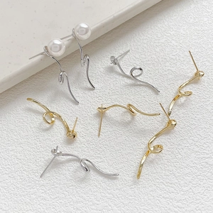 Macro detail of geometric spiral long strip earrings with smooth gold and silver plating