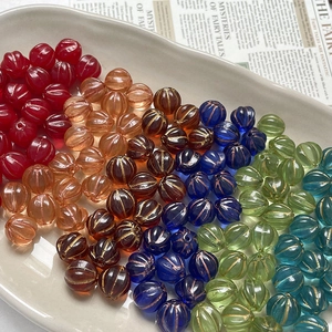 Vintage gold-rimmed Czech glass pumpkin beads in various colors for DIY jewelry making