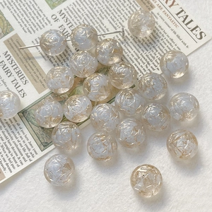 Macro view of translucent glass beads with hand-painted rose relief for DIY jewelry making