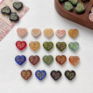 Vintage heart-shaped glass beads with gold floral relief for DIY jewelry making