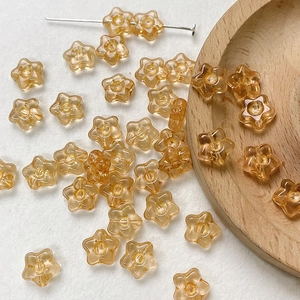 Close-up of amber star-shaped Czech glass beads for DIY bracelet jewelry making