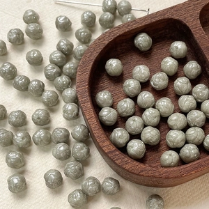 Detail of 8mm light grey-green rose carved Czech glass beads for DIY jewelry making