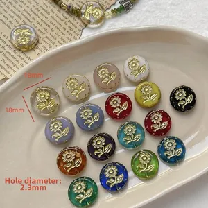 Macro view of 18mm sunflower pattern beads in vibrant resin colors with gold floral details