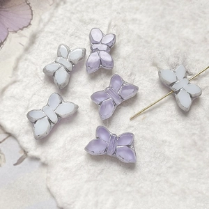 Macro detail of gold-edged butterfly beads for DIY jewelry and handmade bracelets