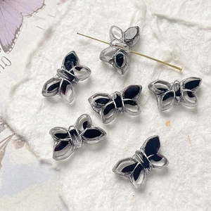 Detailed view of butterfly-shaped Czech glass beads with gold-leaf finish for DIY jewelry