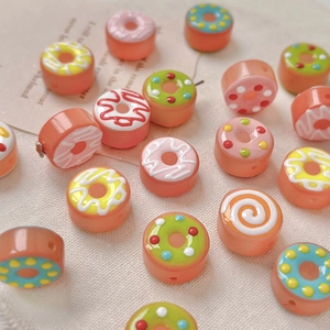 Close-up of colorful resin doughnut beads with icing patterns for DIY jewelry making