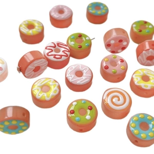 Colorful hand-painted donut glass beads for DIY necklaces and bracelets on white background