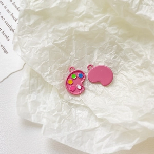 Macro detail of pink enamel artist palette alloy pendants with colorful paint dot accents