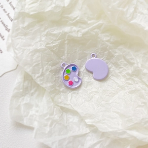 Detail of purple paint palette alloy pendants for DIY jewelry and charm making