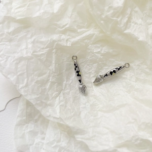 Detailed view of silver alloy paintbrush pendants with Mickey silhouette for DIY jewelry