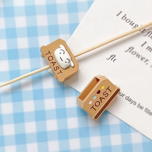 Detailed view of toast-shaped DIY beads with heart pattern and cute cartoon face
