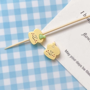Detail of yellow enamel toast charm with cute face for DIY jewelry making and bracelets