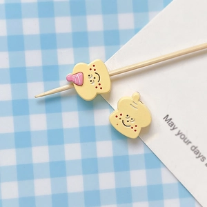 Close-up of cute hand-painted bread toaster charms with smiles for DIY jewelry