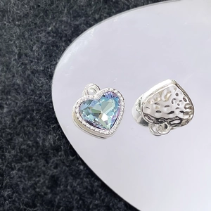 Detail van hartvormige hanger met aurora-steen inleg en gehamerde metalen achterkant