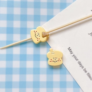Detail shot of cute hand-painted bread toast resin charms for DIY jewelry making