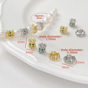 Detailed macro view of 18K gold-plated spacer beads with zircons and precise dimensions