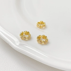 Macro shot of 18K gold plated hollow spacer beads with micro-set cubic zirconia stones