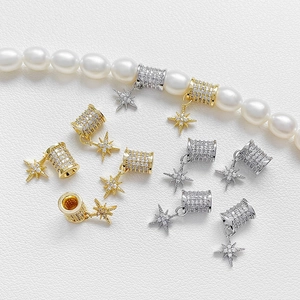 Close-up of 18k gold plated meteor beads with zircon star charms for DIY jewelry making