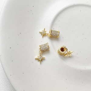 Detailed macro of 18k gold plated meteor beads with white zircon inlay for DIY jewelry