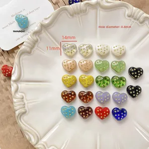 Detail view of 14mm heart glass beads with gold polka dots for DIY jewelry making