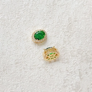 Macro shot of 18k gold plated oval green gemstone spacer bead with zircon detail