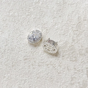 Detail of oval cubic zirconia earrings with micro-pave setting and hollow silver base