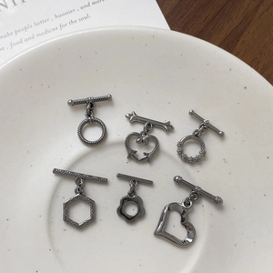 Gunmetal heart and twist OT toggle clasps for DIY jewelry making displayed on white plate