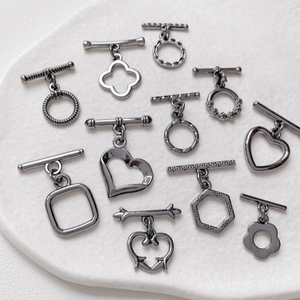 Macro detail of various gun black heart and geometric toggle clasps for DIY jewelry