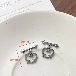 Detailed view of vintage gun black heart-shaped OT toggles with 20mm dimension marks