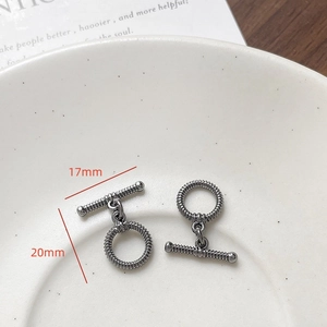 Detail of gunmetal heart-shaped toggle clasp with spiral texture, 20mm ring size