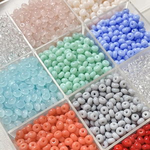 Macro shot of 4mm colorful glass seed beads set in a clear plastic storage box