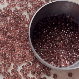Macro shot of 4mm purple glass seed beads with center hole for DIY jewelry making