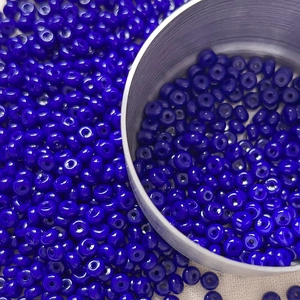 Macro shot of 4mm dark blue glass seed beads for DIY jewelry making and craft projects