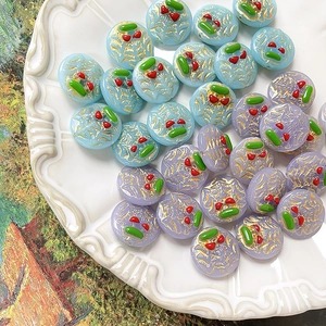 Detail of hand-painted cherry glaze beads with gold silk texture for DIY jewelry