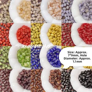 Macro detail of tulip glass beads with gold trim in various colors for DIY jewelry making