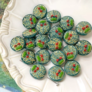 Macro view of handmade cherry pattern green glass beads with gold texture for DIY jewelry