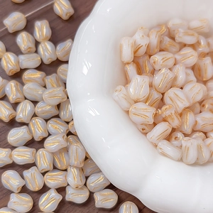 Macro detail of tulip glass beads with gold veins for DIY jewelry making