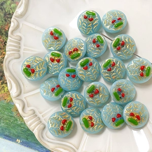 Detail of hand-painted light blue glass beads with gold texture for DIY jewelry making