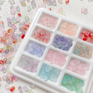 Macro shot of colorful matte rice beads in a white organizer for DIY jewelry making
