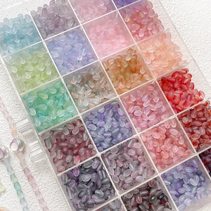 Macro shot of colorful gradient frosted matte acrylic beads in a plastic storage case