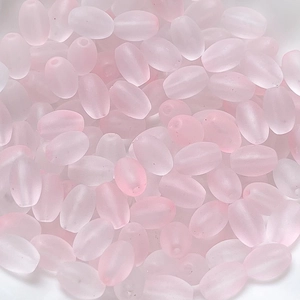 Detailed close-up of pink frosted oval beads with matte finish for DIY jewelry making