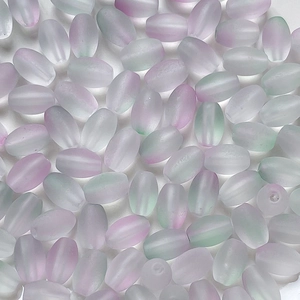 Macro shot of oval frosted gradient glass beads with soft lavender and green tinted edges