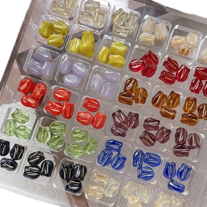 Handmade gold-rimmed tulip glass beads for jewelry making in various vibrant colors