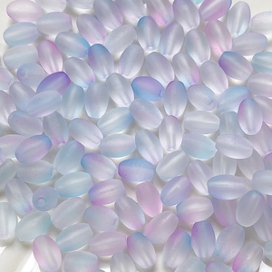 Macro view of frosted gradient rice beads with smooth matte texture and pink-blue tones