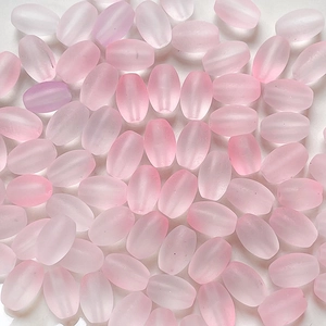 Macro shot of matte pink gradient rice beads for DIY jewelry and necklace making