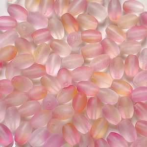 Macro detail of frosted pink gradient seed beads for DIY handmade jewelry crafting