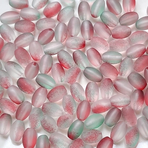 Macro shot of oval frosted gradient beads in pink and green for DIY jewelry making