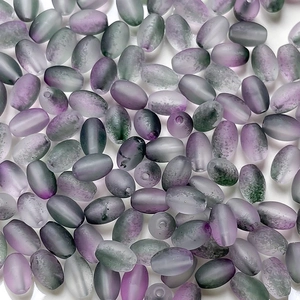 Macro shot of purple and green gradient frosted oval beads for DIY jewelry making