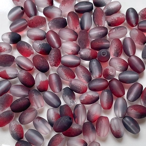 Macro of gradient frosted burgundy rice beads for DIY handmade jewelry and necklaces